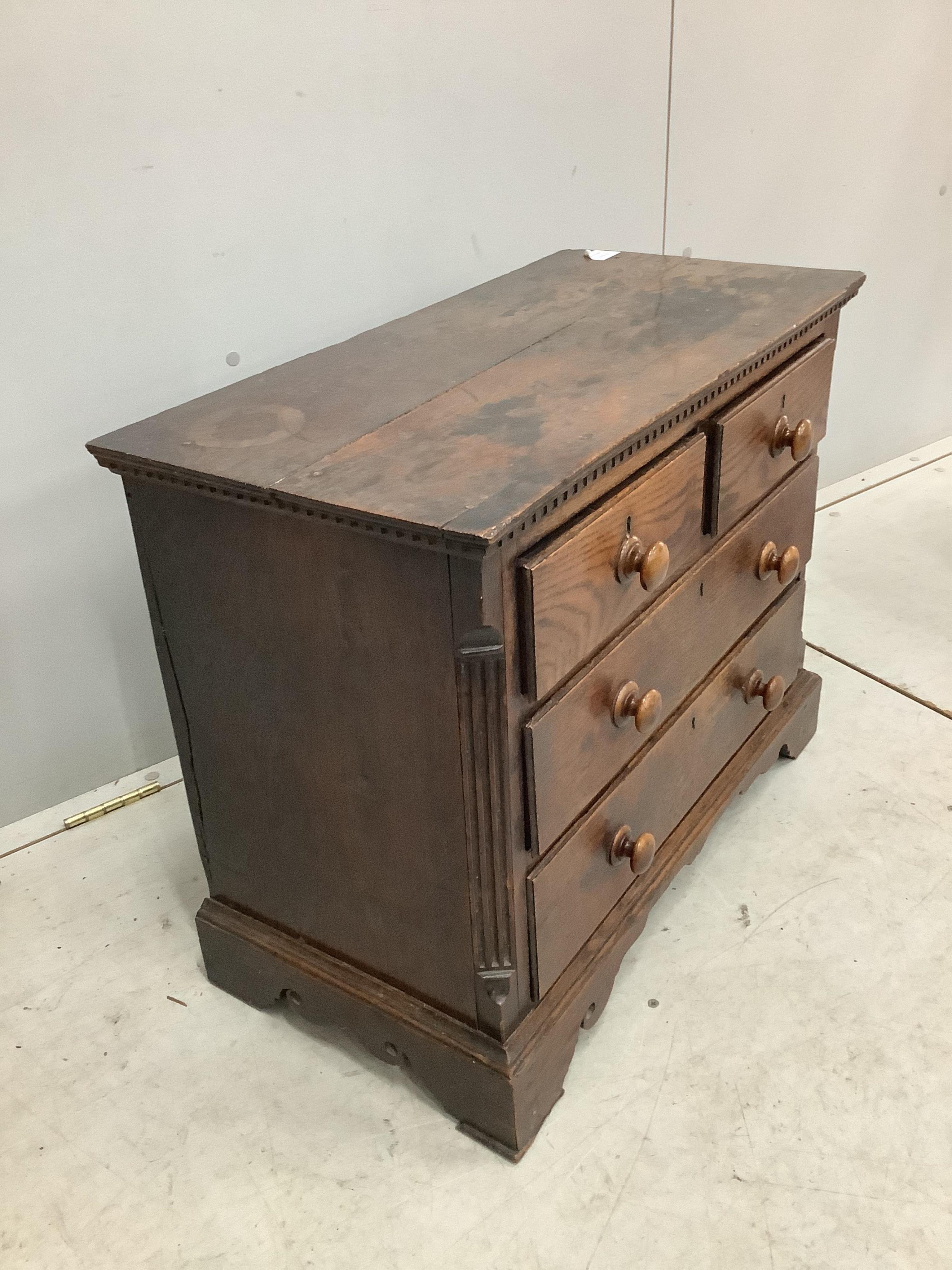 An 18th century miniature oak chest of two short and two long drawers, possibly child’s furniture, width 67cm, depth 34cm, height 55cm. Condition - fair, top timber join separated, one scroll detail missing from right br